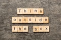 Think outside the box word written on wood block. Think outside the box text on cement table for your desing, Top view Royalty Free Stock Photo