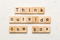Think outside the box word written on wood block. Think outside the box text on cement table for your desing, Top view Royalty Free Stock Photo
