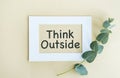 THINK OUTSIDE sticker text in white frame on yellow background