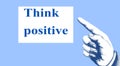 `Think positive`. The direction of the finger points to a motivational and inspirational message. Royalty Free Stock Photo