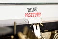 Think positive symbol. Concept words Think positive typed on beautiful old retro typewriter. Beautiful white paper background.