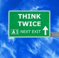 THINK TWICE road sign against clear blue sky