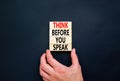 Think before you speak symbol. Concept words Think before you speak on wooden cubes. Beautiful black table black background. Royalty Free Stock Photo