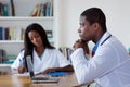 Thinking african american doctor with nurse