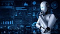 Thinking AI hominoid robot analyzing hologram screen showing concept big data