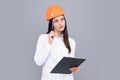 Thinking architect worker, female constructor engineer. Young beautiful architect woman in hard hat helmet hold