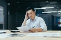 Thinking Asian businessman working in office Royalty Free Stock Photo