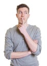 Thinking australian guy in a grey shirt looking sideways Royalty Free Stock Photo