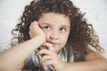 Thinking baby girl curly hair Royalty Free Stock Photo