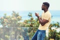 Thinking back at the long year Ive had. a handsome young man having a drink while relaxing outdoors on holiday. Royalty Free Stock Photo