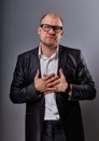 Thinking bald business man holding the chest two hands with serious face in eyeglasse Royalty Free Stock Photo