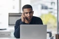 Thinking of the best response to this email. a handsome young businessman sitting alone in his office and looking Royalty Free Stock Photo