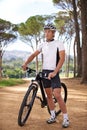 Thinking, bike and break with man in forest for off road fitness, sports or outdoor cardio hobby. Cycling, nature and