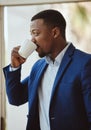 Thinking, black businessman or drinking coffee in airport lounge, hotel lobby or modern office building. Corporate Royalty Free Stock Photo