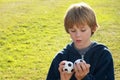 Thinking boy with two balls Royalty Free Stock Photo