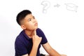 Thinking boy on white background with graduation cap. Royalty Free Stock Photo