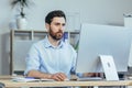 Thinking business man, working in a modern office during the day, sitting at a table, working with a computer, thinking about Royalty Free Stock Photo