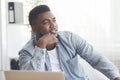 Portrait of pensive black businessman sitting at workplace in office Royalty Free Stock Photo