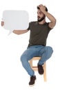 Thinking casual man holding a blank speech bubble