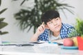 Thinking child bored and fed up doing his homework Royalty Free Stock Photo