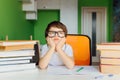 Thinking child bored, frustrated and fed up doing his homework Royalty Free Stock Photo