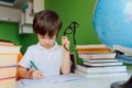 Thinking child bored, frustrated and fed up doing his homework Royalty Free Stock Photo