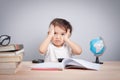 Thinking child bored, frustrated and fed up doing homework Royalty Free Stock Photo