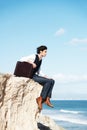 Thinking, cliff and business man sitting by ocean for freedom, opportunity and career in nature. Professional, mockup