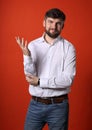 Thinking confused bearded charismatic man in whirt shirt looking