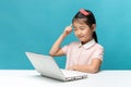 Thinking, Cute asia little girl who enjoy the laptop computer on Royalty Free Stock Photo