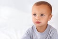 Thinking, cute and boy baby on bed in the nursery of modern home relaxing and sitting. Calm, mockup and serious young Royalty Free Stock Photo