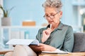 Thinking, documents and business with a senior woman reading while sitting in a chair at work. Data, writing and idea Royalty Free Stock Photo