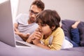 Thinking, father and child with computer for learning in bedroom with connectivity, technology at home. Family, man and Royalty Free Stock Photo