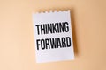 Thinking Forward text on white sticky note on yellow background Royalty Free Stock Photo
