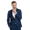 Thinking guy in blue tuxedo standing with hand in pocket Royalty Free Stock Photo