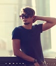 Thinking handsome young man in fashion sun glasses looking on ci Royalty Free Stock Photo