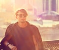 Thinking handsome young man in fashion sun glasses looking on ci Royalty Free Stock Photo