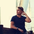 Thinking handsome young man looking on city center background wi Royalty Free Stock Photo