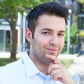 Thinking hispanic guy in a blue shirt Royalty Free Stock Photo