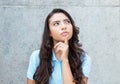 Thinking latin american woman with long hair outdoor in the summer