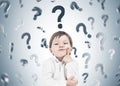 Thinking little boy, question marks rain Royalty Free Stock Photo