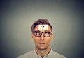 Thinking man in glasses with question mark looking up Royalty Free Stock Photo