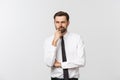 Thinking man isolated on white background. Closeup portrait of a casual young pensive businessman looking up at Royalty Free Stock Photo