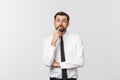 Thinking man isolated on white background. Closeup portrait of a casual young pensive businessman looking up at Royalty Free Stock Photo