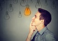 Thinking man looking up with light idea bulb above head Royalty Free Stock Photo