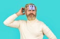 Thinking man with question mark on blue background. Man with question mark on forehead. Paper notes with question marks. Beard man Royalty Free Stock Photo