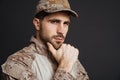 Thinking masculine military man posing and looking at camera
