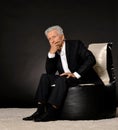 Thinking mature businessman sitting in chair Royalty Free Stock Photo