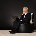 Thinking mature businessman sitting in chair Royalty Free Stock Photo