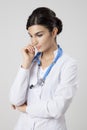 Thinking medical doctor woman with stethoscope. Royalty Free Stock Photo